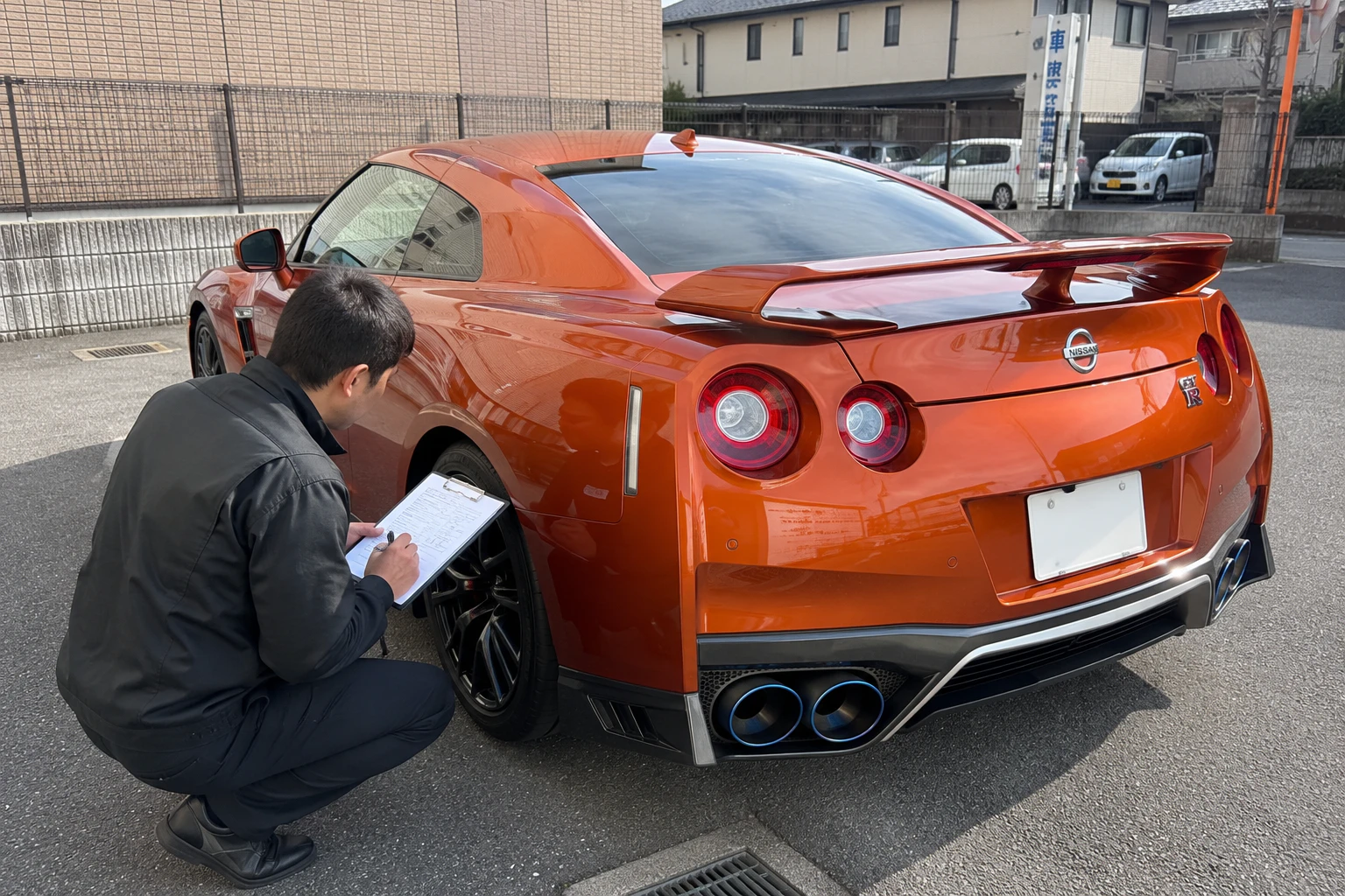 スポーツカーを査定するスタッフ